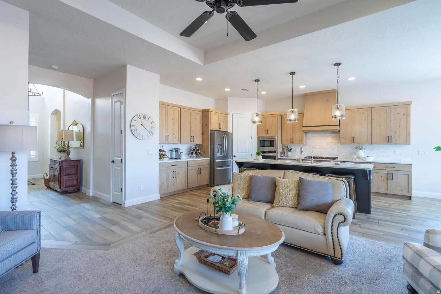 Open concept living space with wood-finish flooring, recessed lighting, and a ceiling fan
