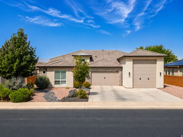 Stucco exterior with stone accents and a tile roof