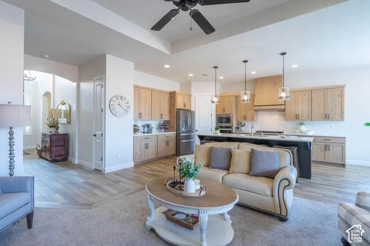Open concept living space with wood-finish flooring, recessed lighting, and a ceiling fan