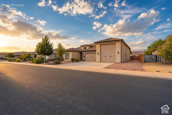 Stucco exterior with a tile roof and multiple garage doors