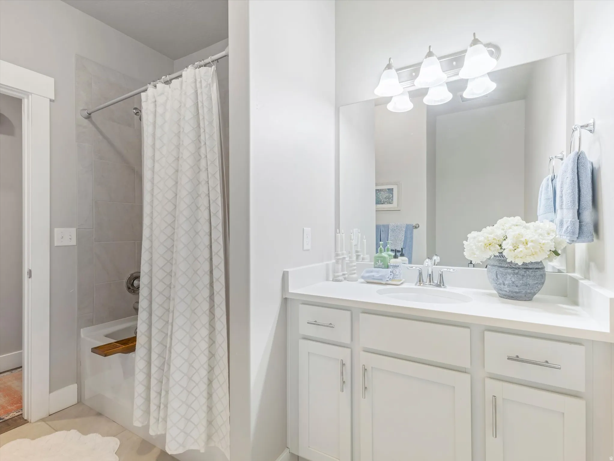 White shaker-style vanity with a white countertop and integrated sink