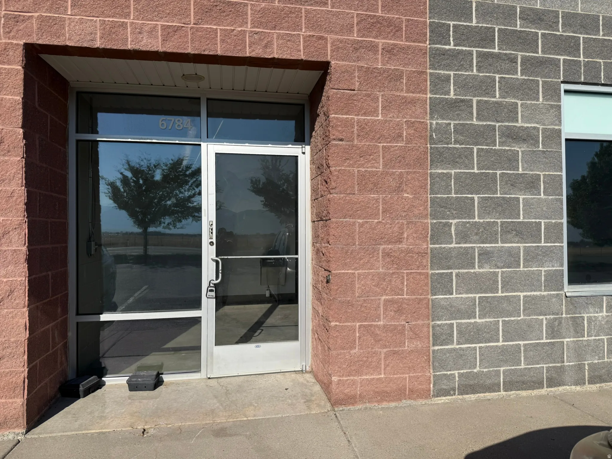 Entryway featuring a full-light glass door, aluminum door frame, and transom window