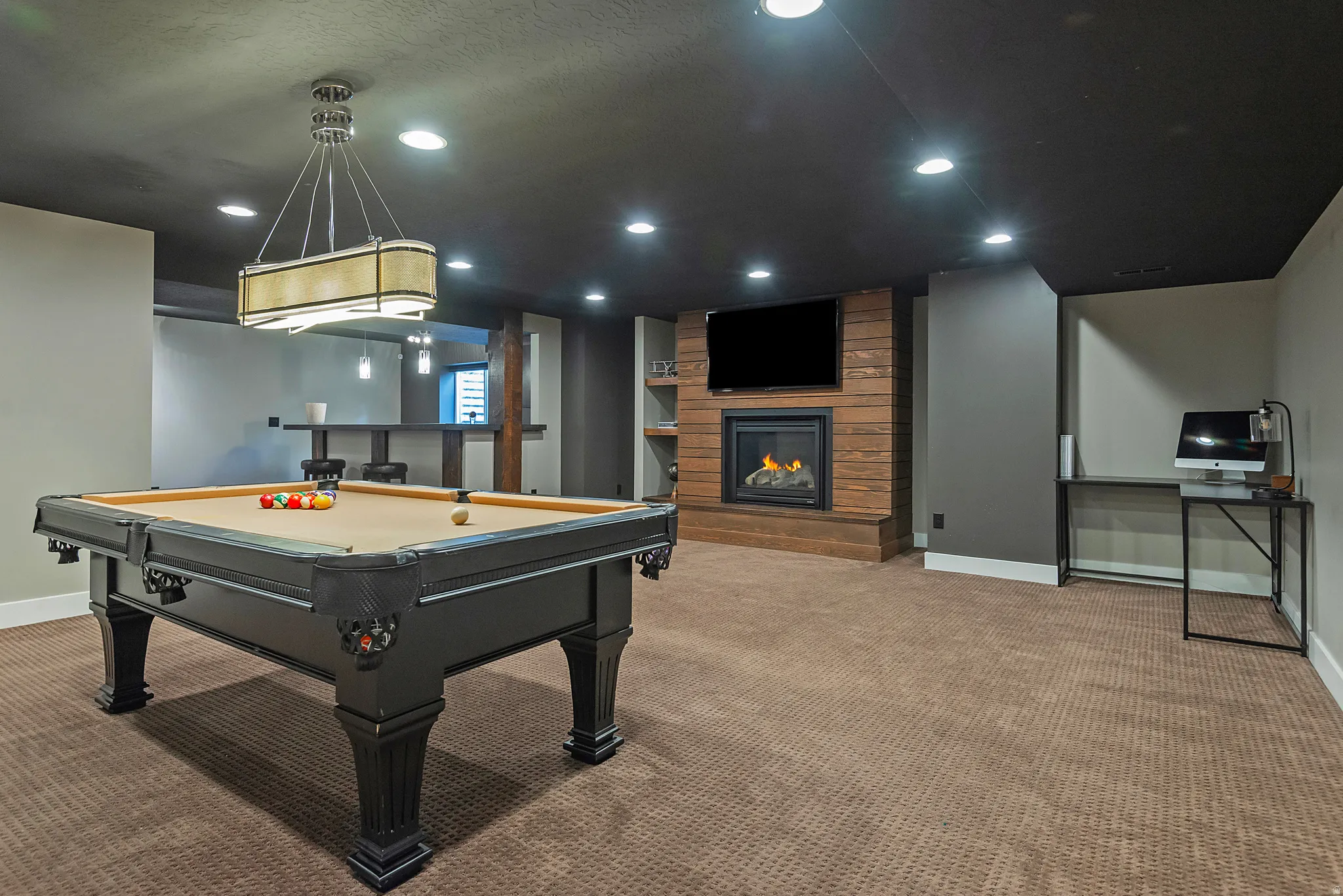 Expansive recreation room featuring a professional-grade pool table, wood-finish flooring, and recessed lighting throughout
