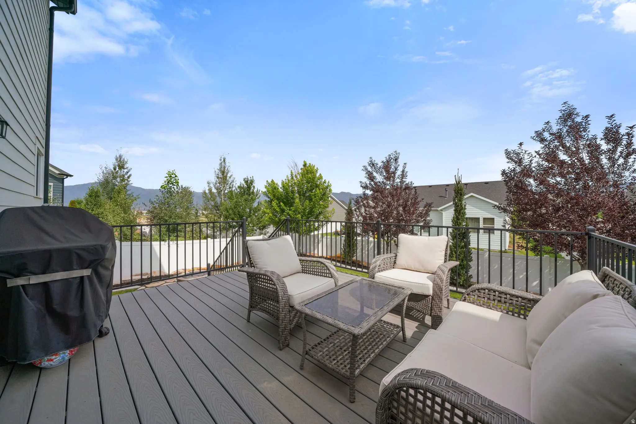 Spacious elevated deck with composite decking and black metal railing