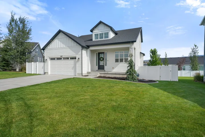 Modern farmhouse exterior with white vertical siding and dark trim