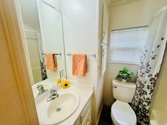 Bathroom vanity with an integrated sink, polished chrome faucet, and expansive wall-mounted mirror