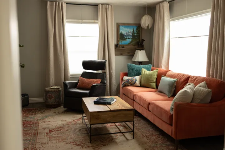 Interior space with light gray walls, two windows, and dark flooring