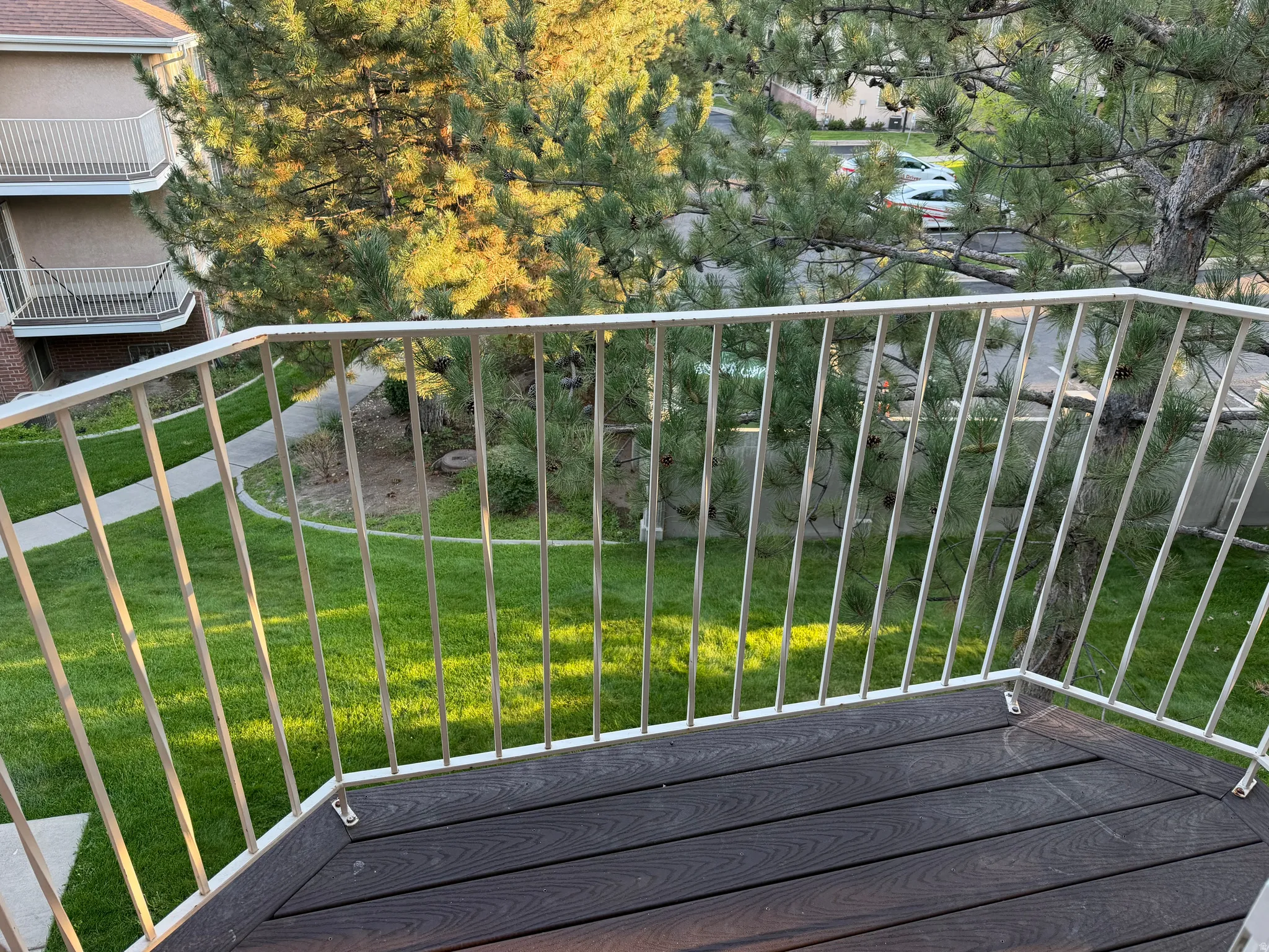 Balcony featuring durable composite decking and a white metal railing