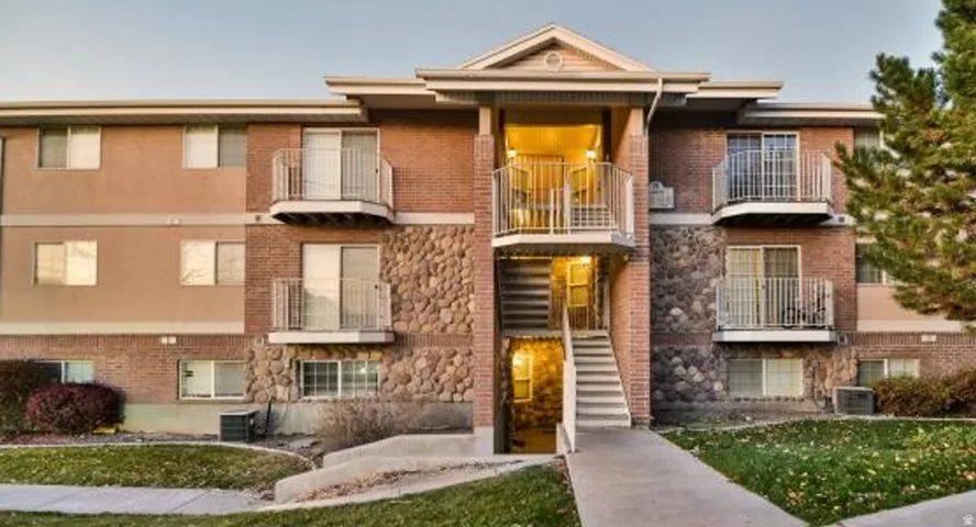 Multi-story building featuring brick and stone veneer accents