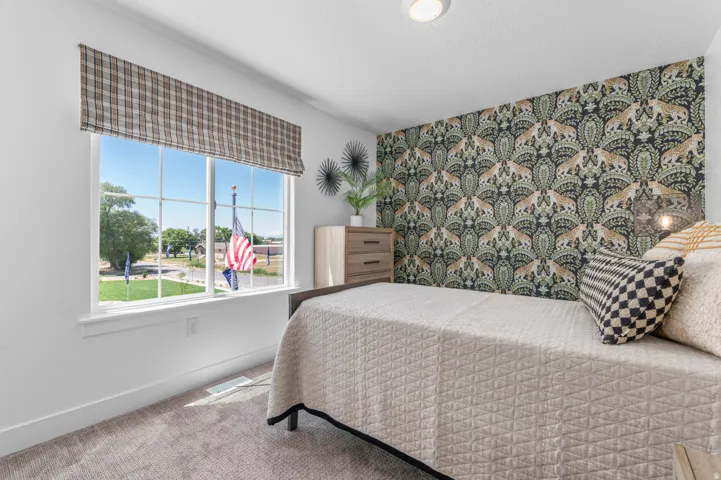 Single-pane window with a plaid Roman shade, complemented by textured carpeting and a patterned accent wall