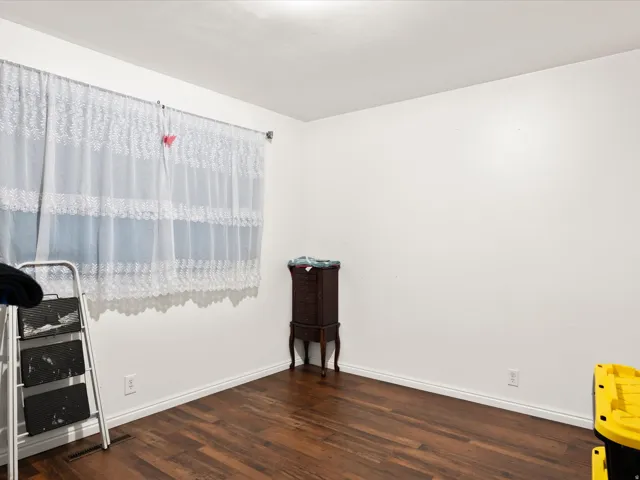 Wood-finish flooring with white walls and trim