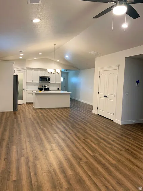 Kitchen with white shaker cabinetry, stainless steel appliances, and a central island