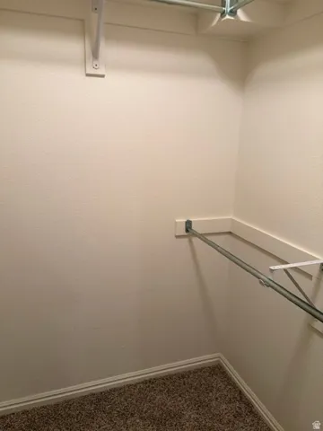 Built-in closet shelving and hanging rods Walk-in master closet