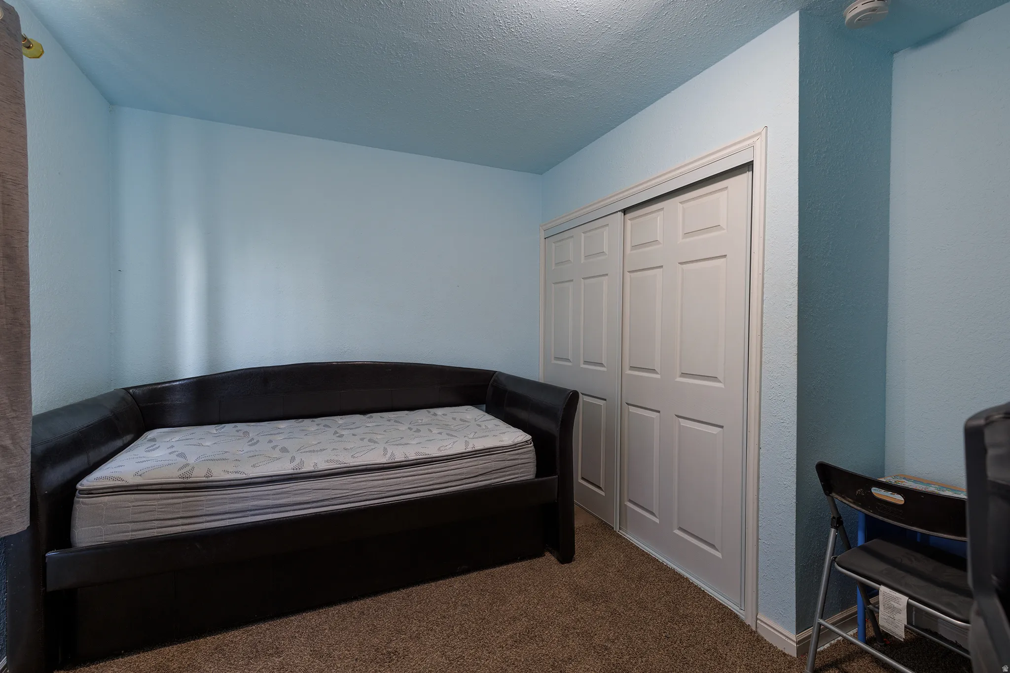 Wall-to-wall carpeting with light blue painted walls