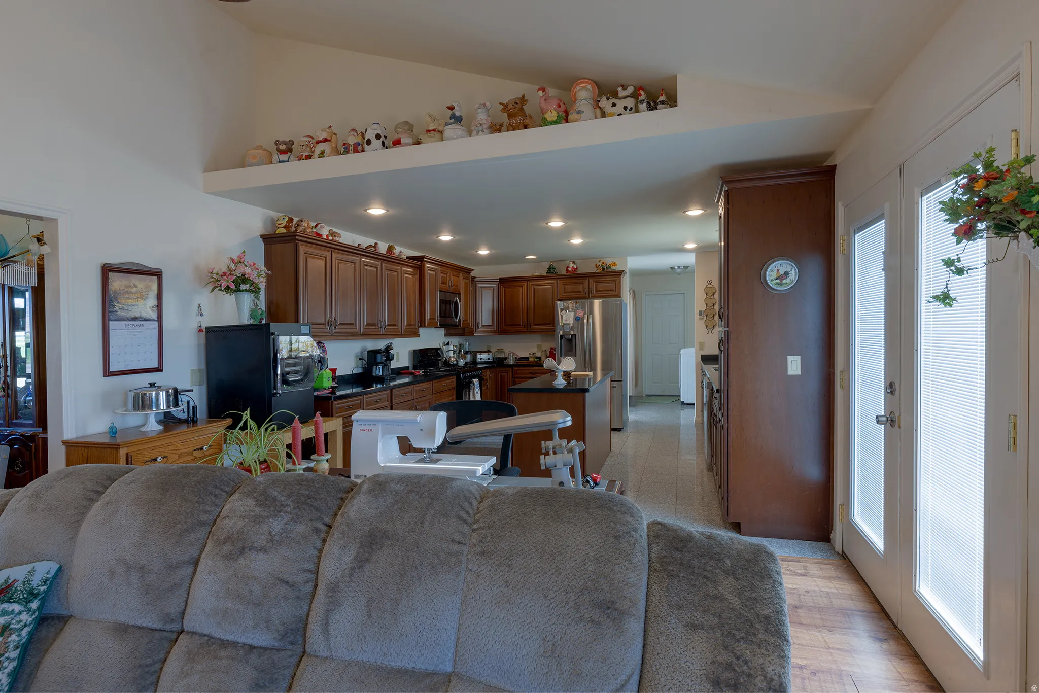 Kitchen featuring wood-finish cabinetry, black countertops, and stainless steel appliances