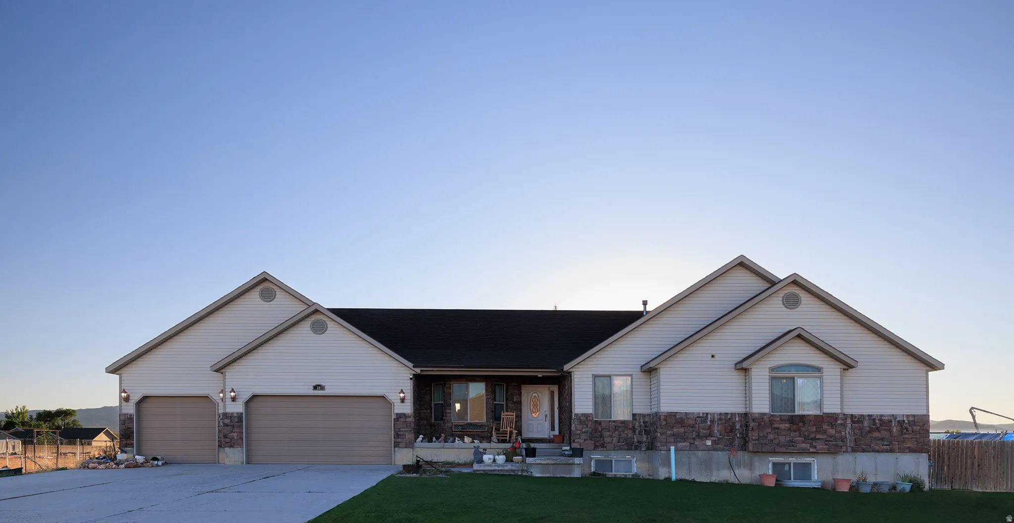 Ranch-style exterior with stone veneer and horizontal siding