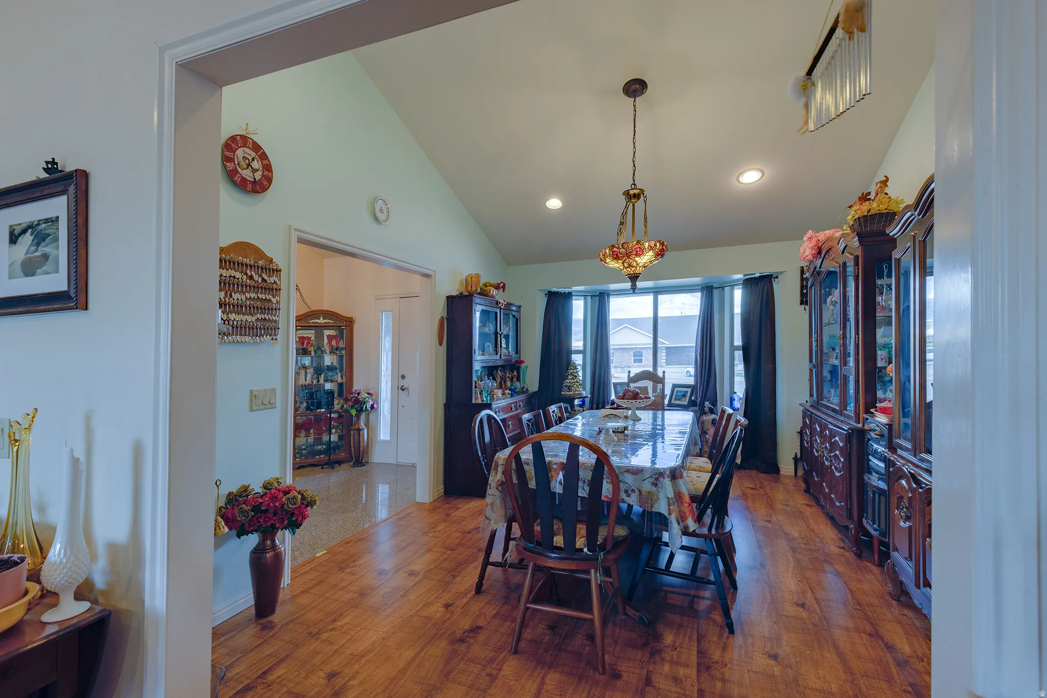 Vaulted ceilings, recessed lighting, wood-finish flooring, and a bay window