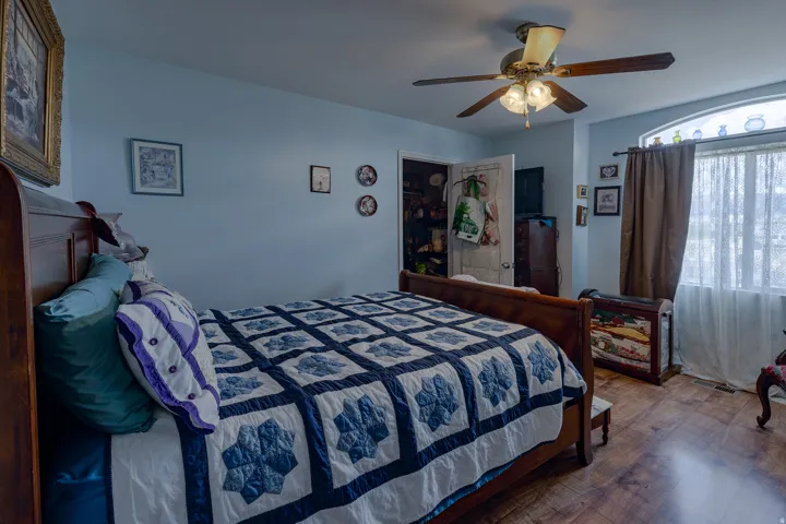 Wood-finish flooring with a ceiling fan light fixture