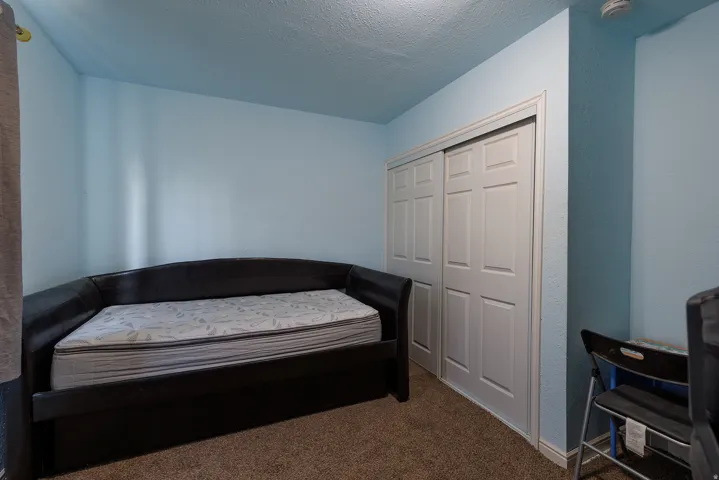 Wall-to-wall carpeting with light blue painted walls