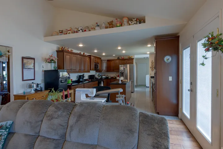 Kitchen featuring wood-finish cabinetry, black countertops, and stainless steel appliances