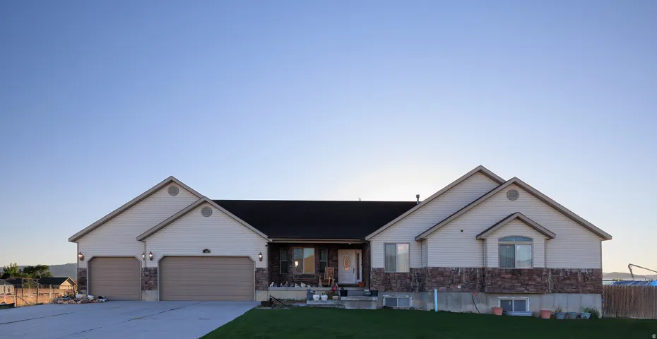 Ranch-style exterior with stone veneer and horizontal siding