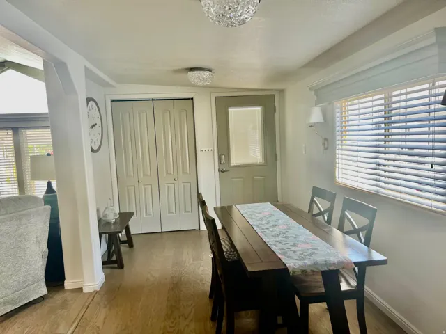 Wood-finish flooring, recessed lighting, and a window with blinds and valance