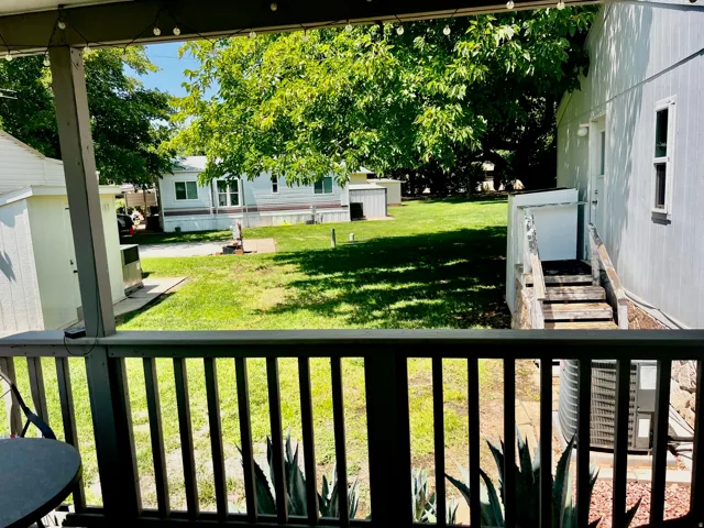Covered outdoor deck with baluster railing