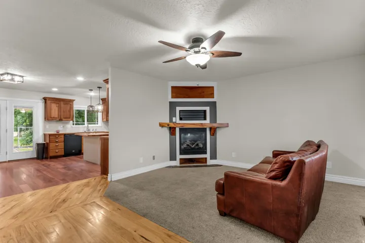 Living area with a built-in fireplace featuring a wood mantel