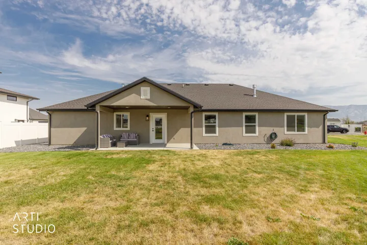 Charming ranch-style home featuring a covered front porch, gabled roofline, and attached two-car garage
