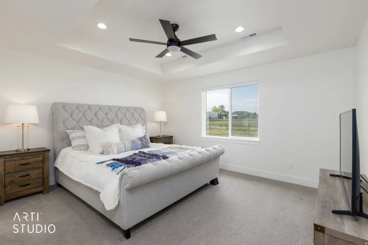 Tray ceiling with recessed lighting and a black ceiling fan