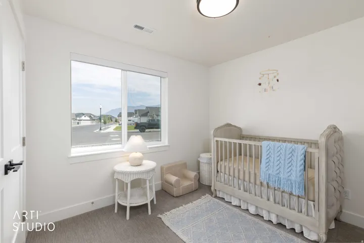White interior walls with a single window, carpeted flooring, and a flush-mount ceiling light fixture