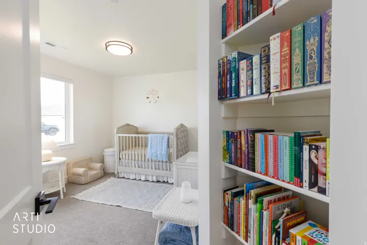 Recessed built-in shelving, white walls, and a flush mount ceiling light