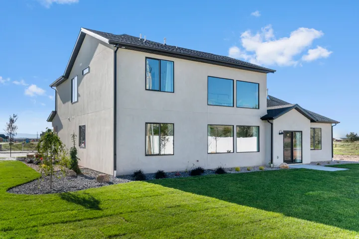 Contemporary exterior with stucco siding and black-trimmed windows