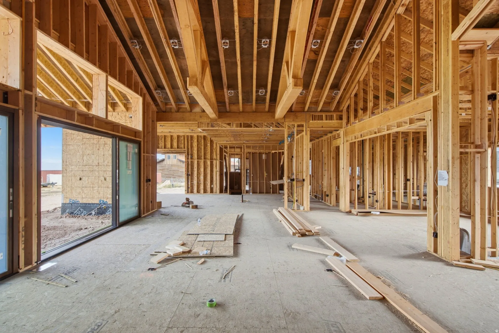 Great Room - covered patio to the left; office/den to the right; kitchen in the background.