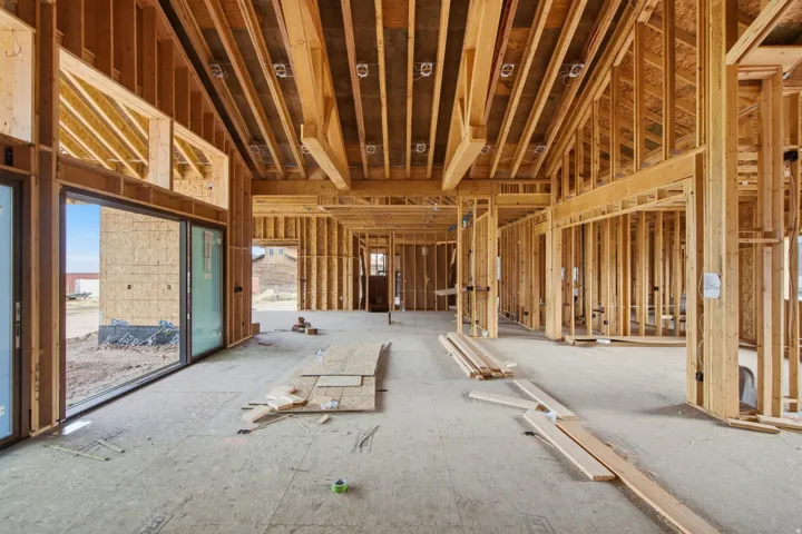 Great Room - covered patio to the left; office/den to the right; kitchen in the background.