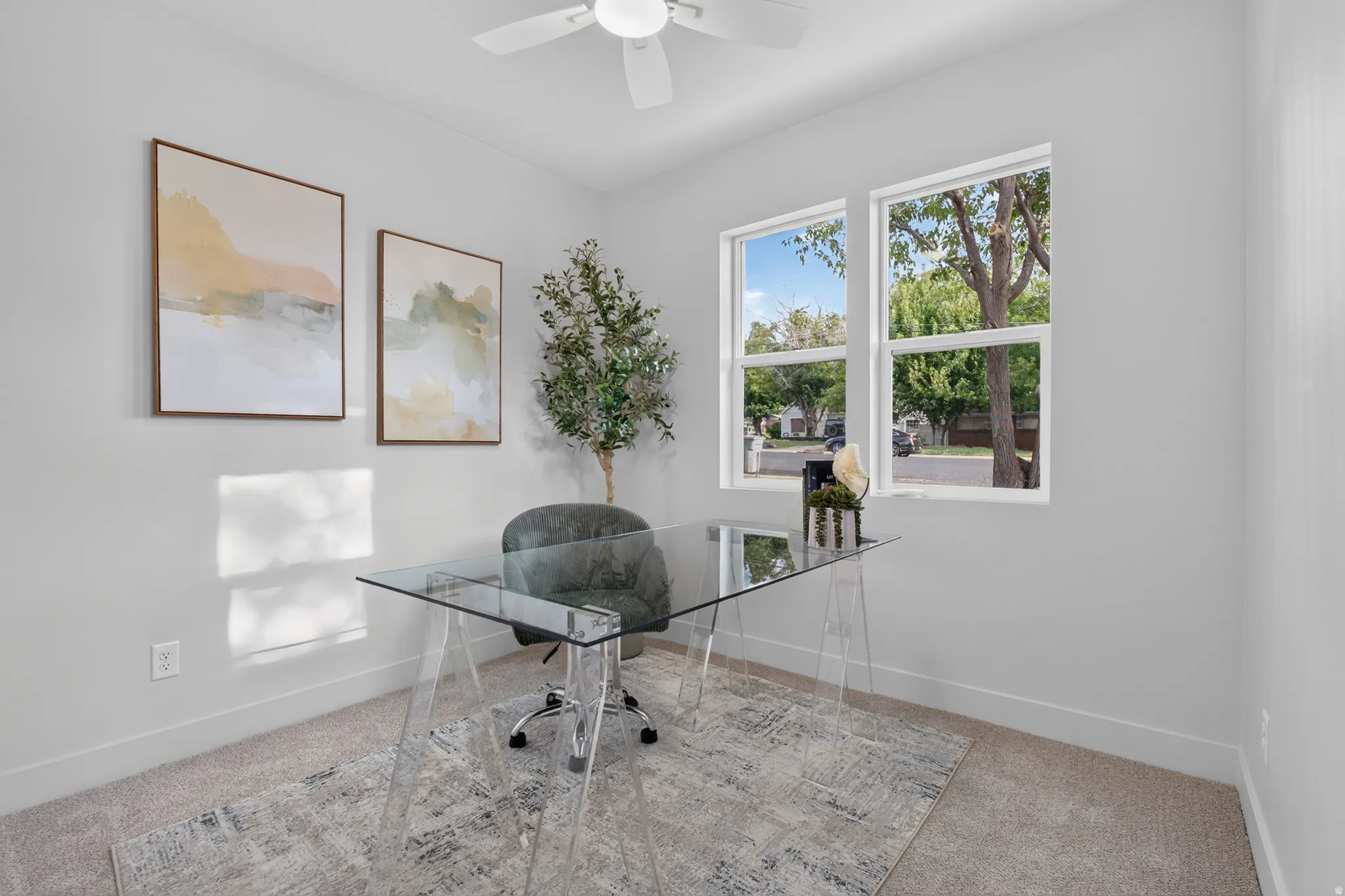 Neutral wall color, dual pane windows, ceiling fan, and carpeted flooring