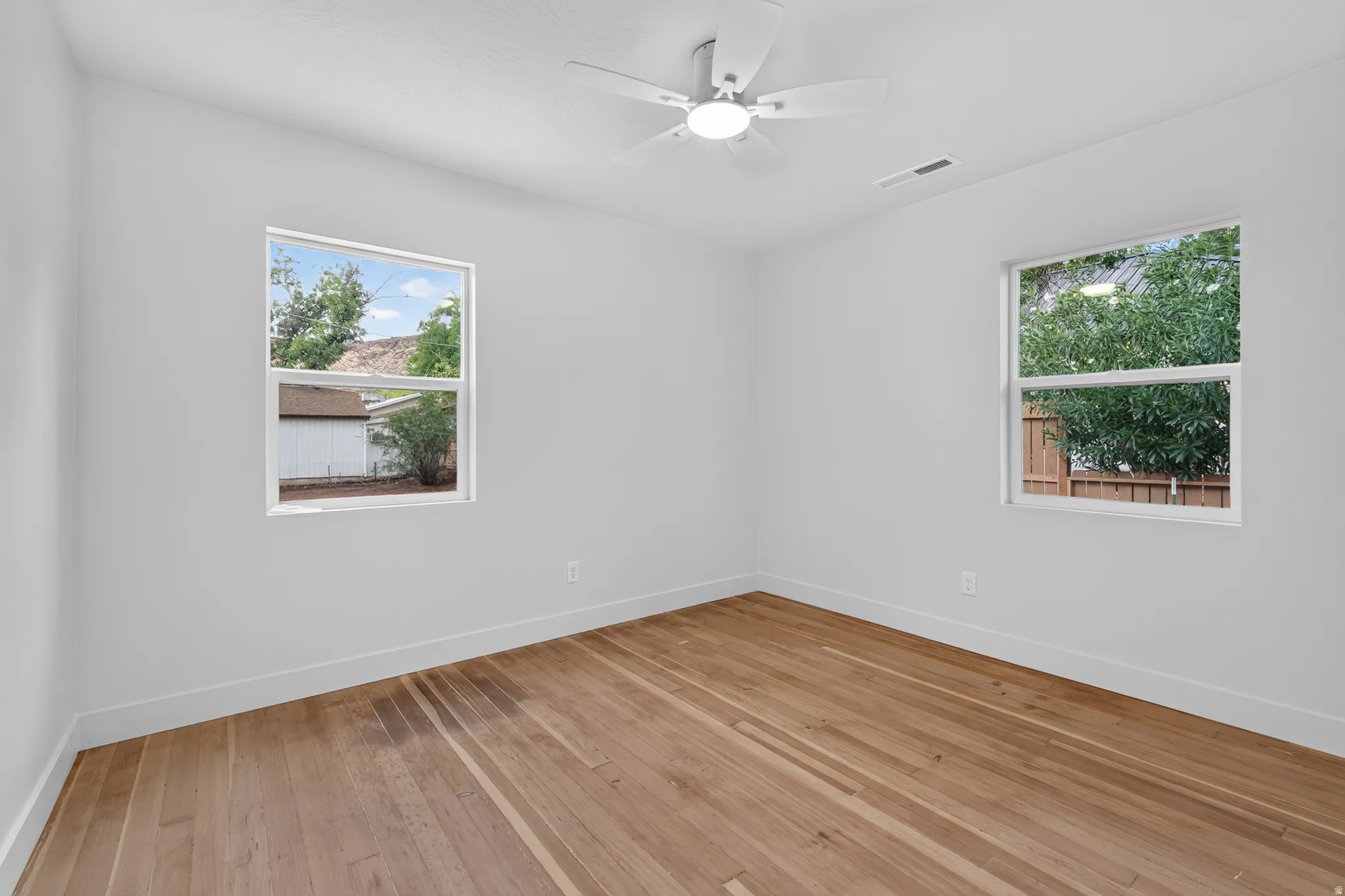 Warm wood-finish flooring complements crisp white walls