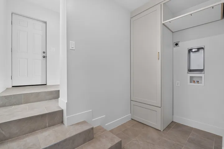 Built-in cabinetry, tile flooring, and light wall finishes