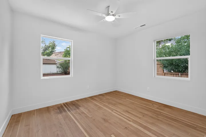 Warm wood-finish flooring complements crisp white walls