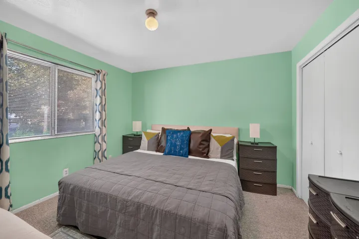 Light green wall paint and wall-to-wall carpeting