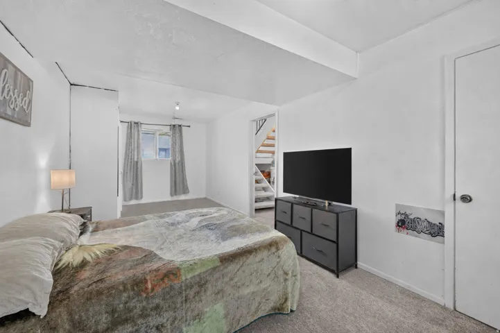 Carpeted flooring throughout, recessed window, ceiling-mounted light fixture, and interior doors