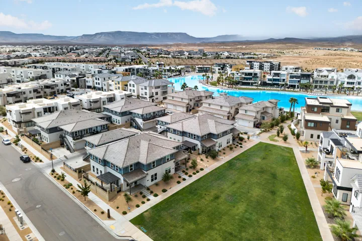 Expansive community featuring diverse architectural styles, a large artificial lagoon, and manicured green spaces