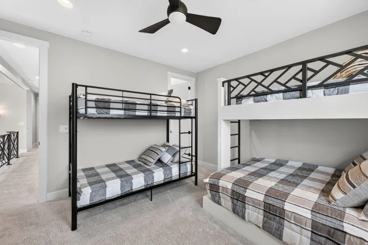 Recessed lighting, wall-to-wall carpeting, and a ceiling fan