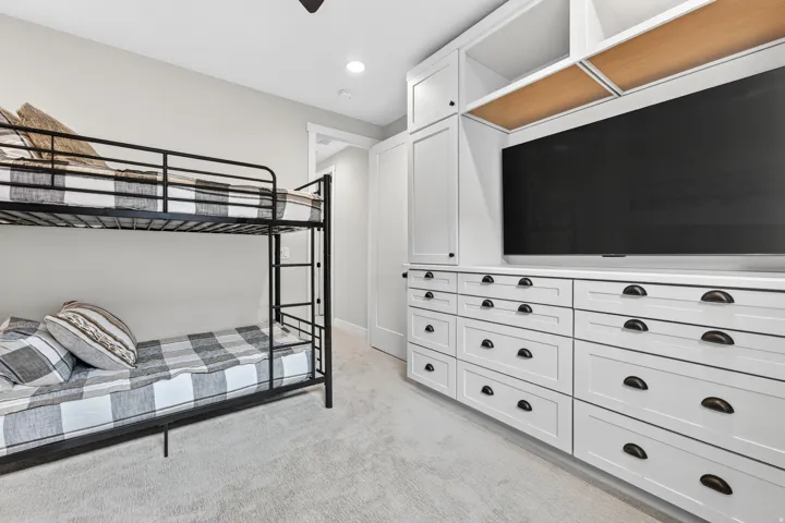 Built-in cabinetry with integrated shelving, matte black hardware, and wood-finish accents