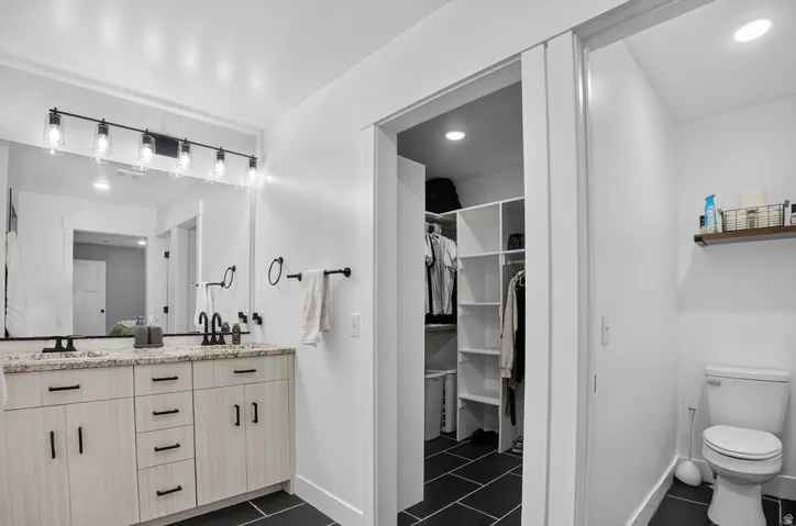 Dual vanity with light-tone cabinetry and dark hardware