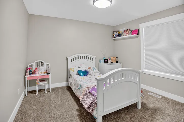Neutral wall color with white trim and carpeting