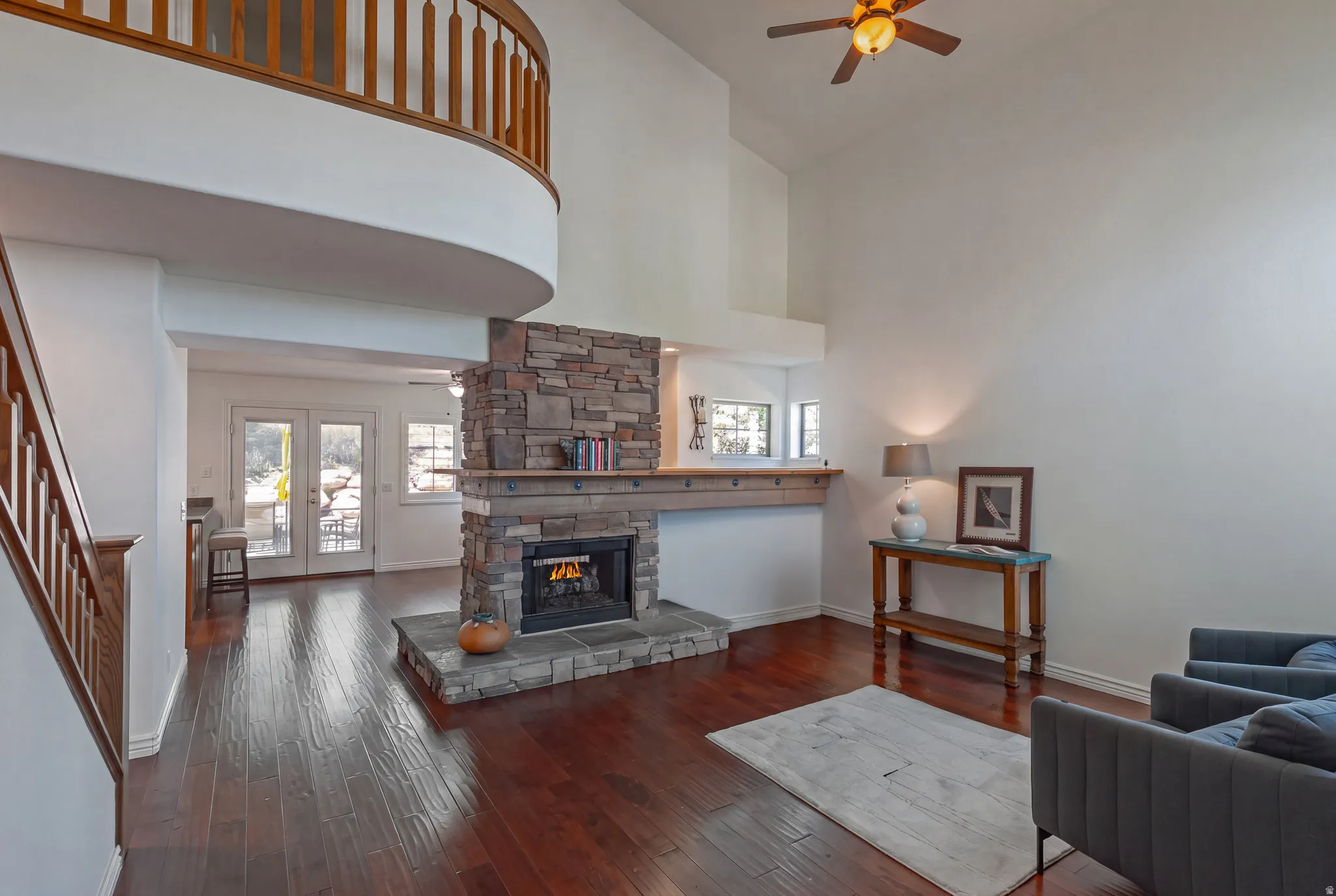 Living Area to the Family Room beyond the Two-Sided Fireplace