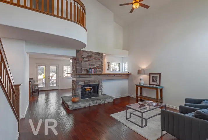 Living Area to the Family Room beyond the Two-Sided Fireplace