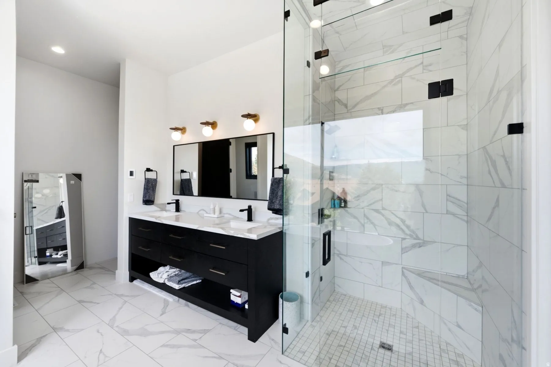 Dual vanity with black cabinetry, white countertops, and matte black fixtures