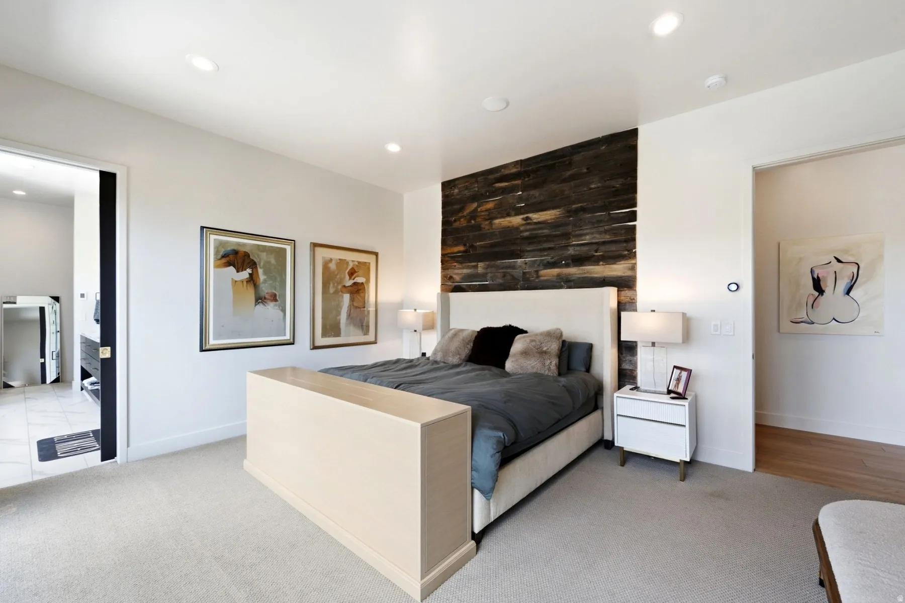 Recessed lighting, wood-finish accent wall, and wall-to-wall carpeting